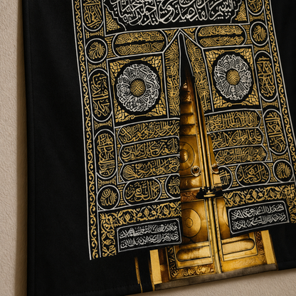 Close-up of black and gold Arabic calligraphy on the Islamic wall hanging